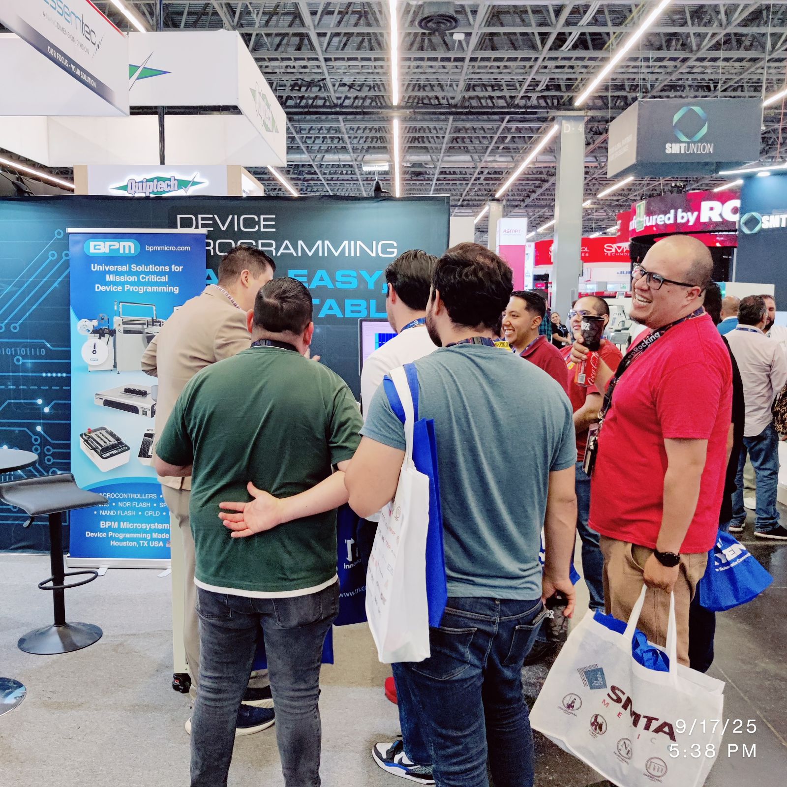 Attendees gathered around the BPM310 Hybrid and BPM team discussing workflows